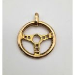 A 9 K yellow gold steering wheel pendant/charm. Weight: 5.1 g.