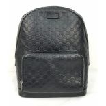 A Gucci Signature GG Black Leather Backpack. Outer zipped compartment. Roomy interior with clip