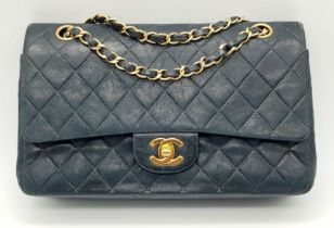 A Classic Chanel Vintage Flap Bag. Calf skin midnight blue quilted leather. Gilded hardware. Black