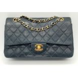 A Classic Chanel Vintage Flap Bag. Calf skin midnight blue quilted leather. Gilded hardware. Black