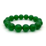 A Chinese Green Jade Bead Expandable Bracelet. 10mm beads.