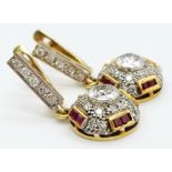 A vintage, 18 K yellow gold pair of earrings with diamonds ( 1 carat appr.) and rubies. weight: 8.