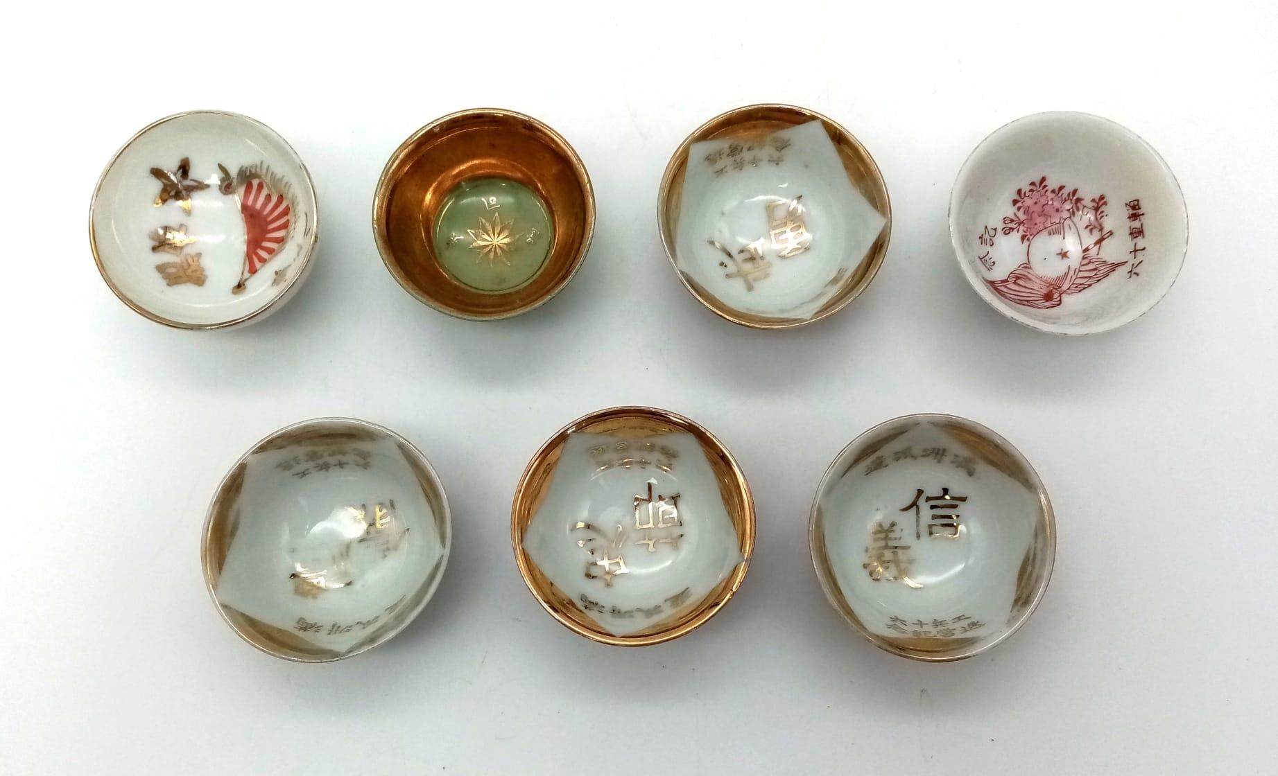 An Assortment of 7 Antique Japanese Bone China Saki cups. good condition for age, some nicely