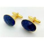 A pair of Faceted, Lapis Lazuli Cufflinks, on yellow metal.