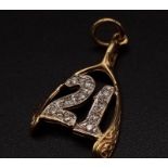 A 9K yellow gold pendant/charm in the shape of a wishbone with the number 21 covered with cubic