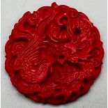 A Chinese Hand-Carved Cinnabar Dragon Circular Pendant. 5cm diameter.