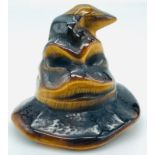 A Harry Potter House-Sorting Tigers Eye Hat Figure.