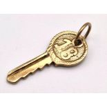 A 9 k yellow gold "18" key charm/pendant. weight: 1.7 g.