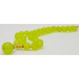 A Peridot Bead Necklace with Gilded Hanging Graduating Peridots. 8/14mm beads. Gilded clasp. 4cm and