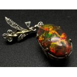 A Vintage high quality vibrant colour black opal - red, green, and fire hints). Estimated 8ct. Set