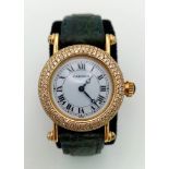 A Cartier 18K Gold and Diamond Ladies Watch. Leather strap with gold Cartier clasp. 18k gold