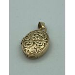 Small and dainty 9 carat GOLD LOCKET, Oval shape with attractive scroll design to front. 0.84 grams.