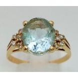 A Vintage 18K Yellow Gold Aquamarine and Diamond Ring. Central oval 3ct aquamarine with five round
