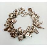 A Vintage 925 Silver Charm Bracelet. Over 20 eclectic charms including a horse shoe and rocking