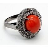 A 3.50cts Natural Coral Ring set in 925 silver decorated with 0.72ct Diamond Accents surround.