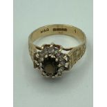 9 carat GOLD RING having oval TOURMALINE set to top with white Topaz surround. Attractive textured