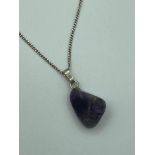 Rough AMETHYST GEMSTONE PENDANT,Polished and mounted on a SILVER CHAIN. 45 cm.