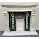 A faux polished marble fire surround in the Classical style with floral decorated frieze and