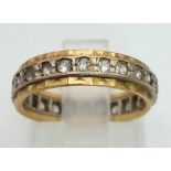 An 18K Yellow and White Gold White Stone Eternity Ring. Size J. 3.43g total weight.
