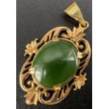 A Vintage Possibly Antique 9K Rose Gold and Jade Cabochon Pendant. Scroll decorative setting.