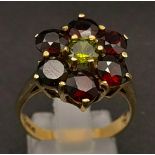 A 9K gold garnet and peridot cluster ring. Size R. 5.05g total weight. Ref:10