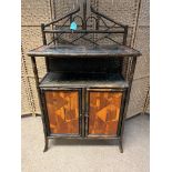 An Antique Bamboo Cabinet with Double Cupboard Doors. The top shelf of the cabinet has decorative