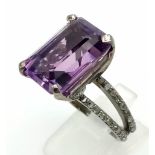 A 14.35ct Natural Amethyst Ring set in 925 silver, decorated with 0.50cts Diamonds on the wings.