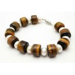 A Tigers Eye and Pearl Bracelet. Tigers eye and cultured pear rondelles with a silver tone