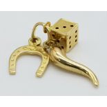 A 9 K yellow gold dice, horse-shoe, and cornucopia GOOD LUCK charm, weight: 0.8 g.