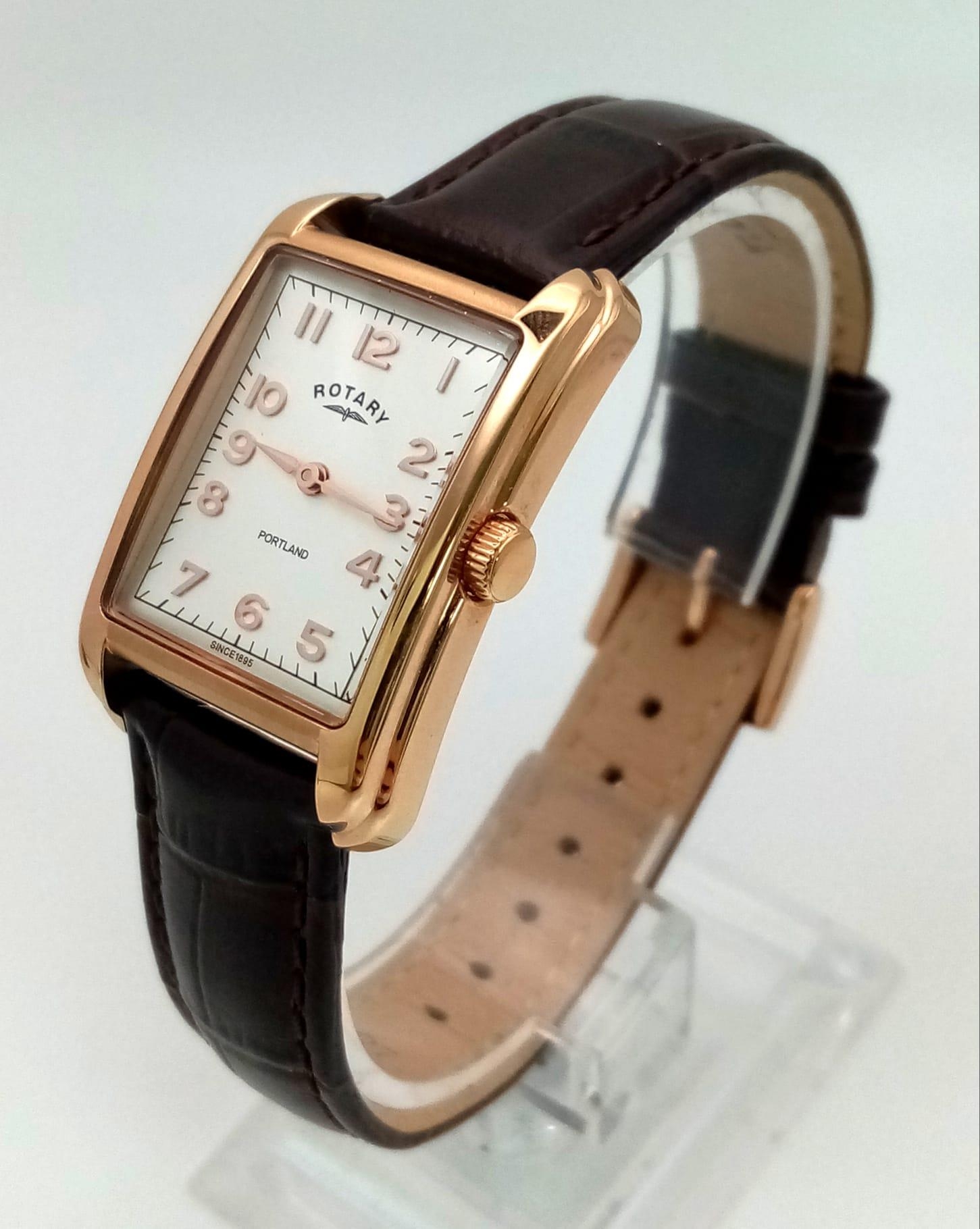 A Ladies Rose Gold Plated Rotary Portland Watch. Brown leather strap. Two-tone case - 25mm width.