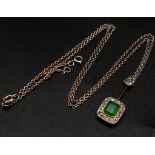 An Emerald and Diamond Pendant on a Yellow Metal Chain. Rectangular emerald with a diamond