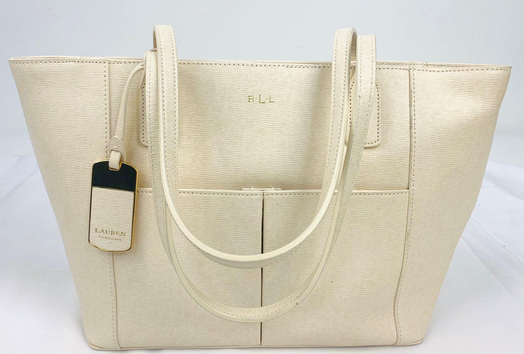 A Ralph Lauren Cream Leather Handbag. Two exterior flaps. Zipped inner compartment. 36cm width. 26cm