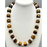 A Tigers Eye Rondelle Bead and Cultured Freshwater Pearl Necklace. Gilded clasp. 44cm.