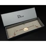 A Christian Dior Gilded Tag Bracelet. Excellent condition. Comes in a Dior box. Ref: 11949