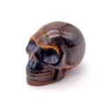 A Hand-Carved Tigers Eye Skull Figure. 6cm
