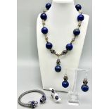 A Tibetan silver and large lapis lazuli beaded parure set in a presentation box. Necklace length: 47