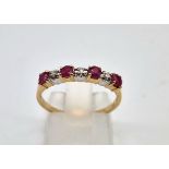 A 9 K yellow gold diamond and ruby band ring. Size: N, weight: 1.3 g.