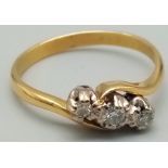 A Vintage 18K Yellow Gold Diamond Trilogy Crossover Ring. Three bright round-cut diamonds. Size R.