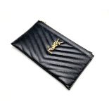 A Yves Saint Laurent Black Leather Clutch Bag. Chevron design. Gilded YSL emblem. Dust cover and