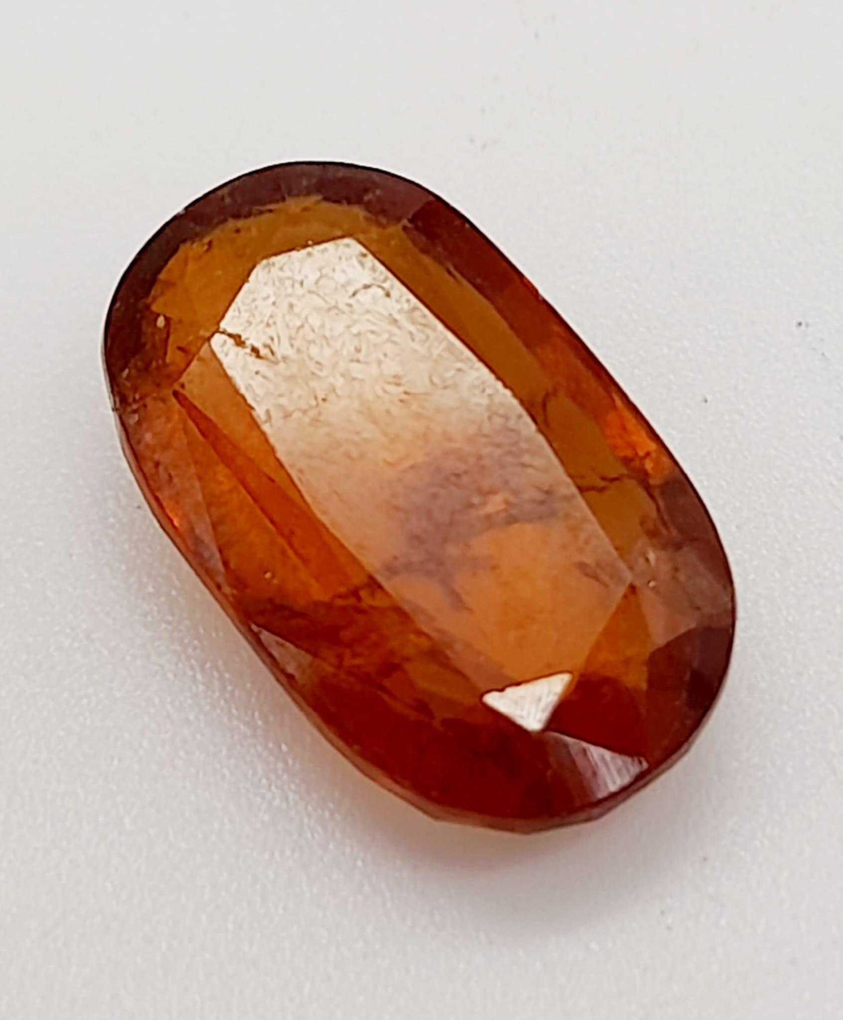 A 6.90ct Faceted Natural Hessonite Garnet, in an Oval Shape cut. Come with the GLI Certificate. - Image 3 of 6