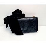 A Christian Louboutin Black Leather Handbag. Fold tone chain handle with velvet bow. Red textile
