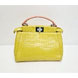 A Fendi Peekaboo Yellow Crocodile Bag. Twist closures. Two interiors with compartments. Silver-
