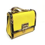 A Dolce and Gabbana Monica Bag. Yellow leather and python exterior. Flap closure. Gilded hardware.