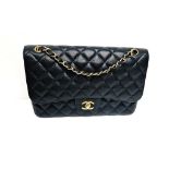 A Classic Chanel Jumbo Flap Bag. Quilted caviar black calfskin. Double flaps. Interior zipped