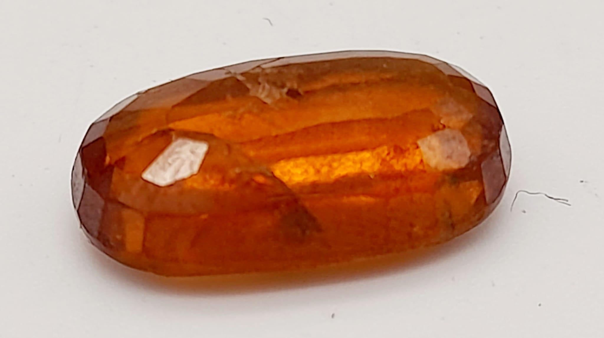 A 6.90ct Faceted Natural Hessonite Garnet, in an Oval Shape cut. Come with the GLI Certificate. - Image 2 of 6