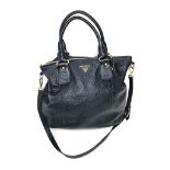 A Large Prada Black Leather Bag. Gold-tone hardware. Shoulder strap. Spacious interior with zipped