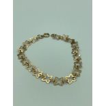 9 carat GOLD BRACELET linked with connecting four point stars and having a Full UK hallmark. 2.48