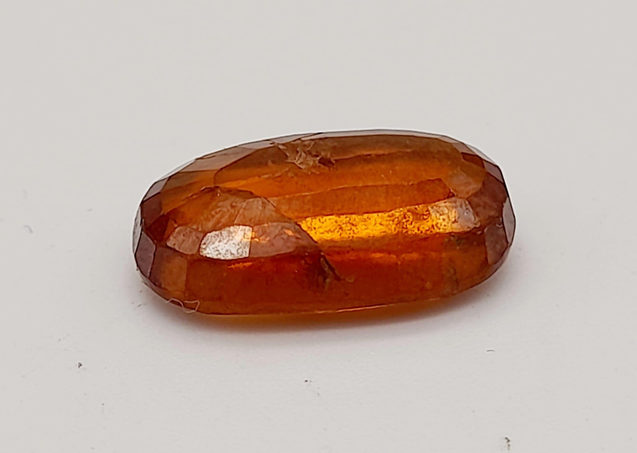 A 6.90ct Faceted Natural Hessonite Garnet, in an Oval Shape cut. Come with the GLI Certificate. - Image 4 of 6