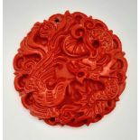 A Chinese Red Cinnabar Dragon Pendant. 5cm diameter.