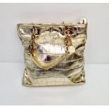 A Metallic Faux Leather Versace Tote Bag. Gold-tone hardware. Dual handles. Spacious interior with